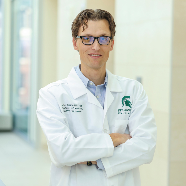 Jeffrey Klomp wearing a lab coat in the research center.