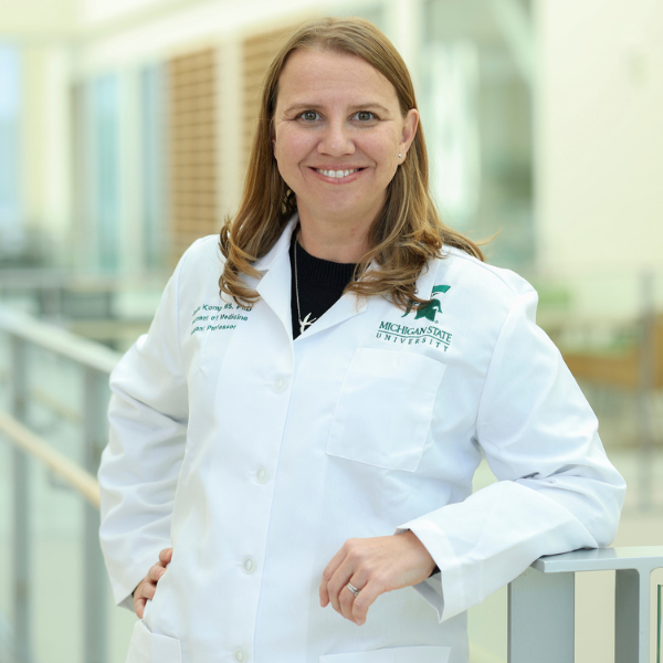 Jennifer Klomp wearing a lab coat in the research center.